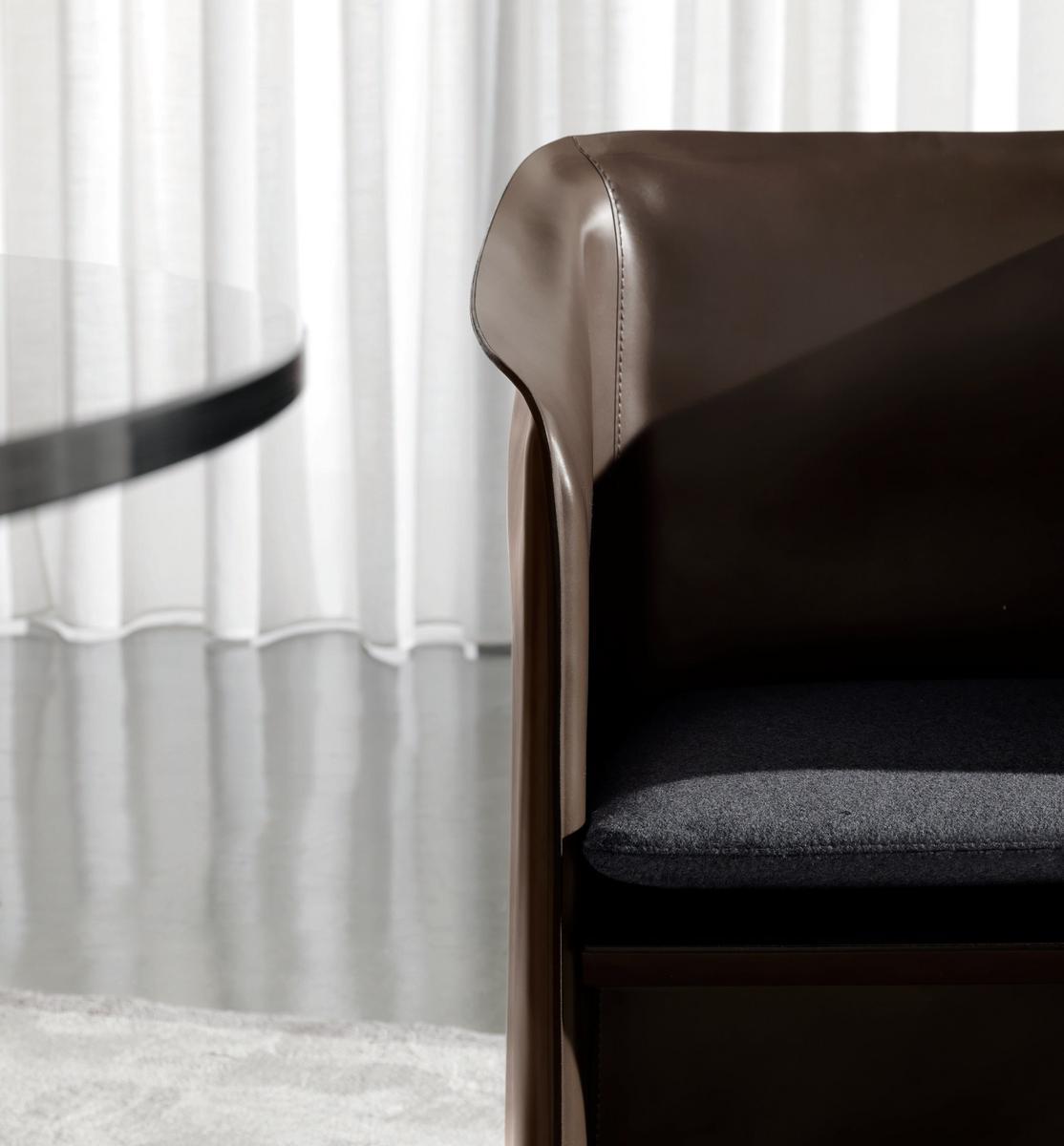 CASE Upholstered tanned leather chair with armrests
