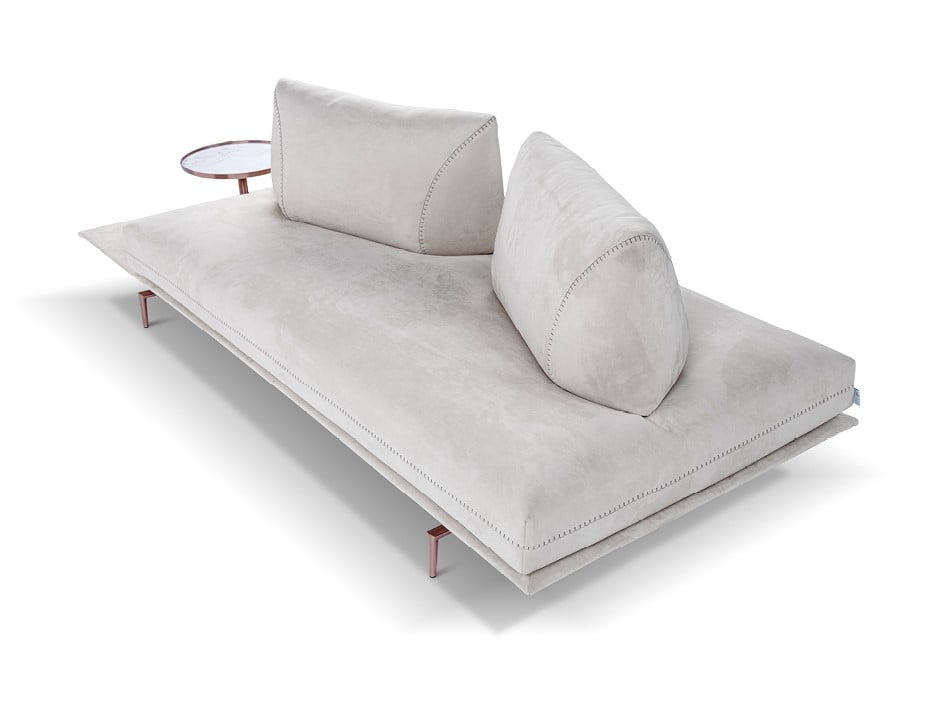 GIANDUIOTTO A versatile sofa offering adjustable backrests for multiple seating positions, elegant design stitching, and optional integrated table surfaces, elevated by stylish metal feet.